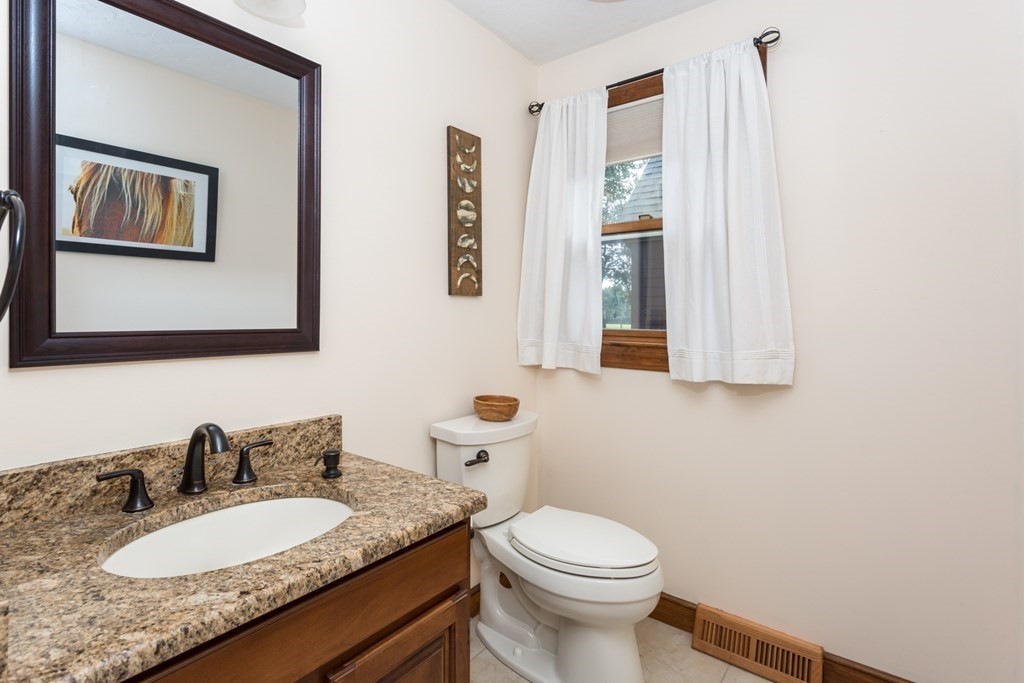 8 Mill River Drive Mendon, MA 01756 - Photo 21 of 42 a bathroom with a granite countertop sink and a mirror