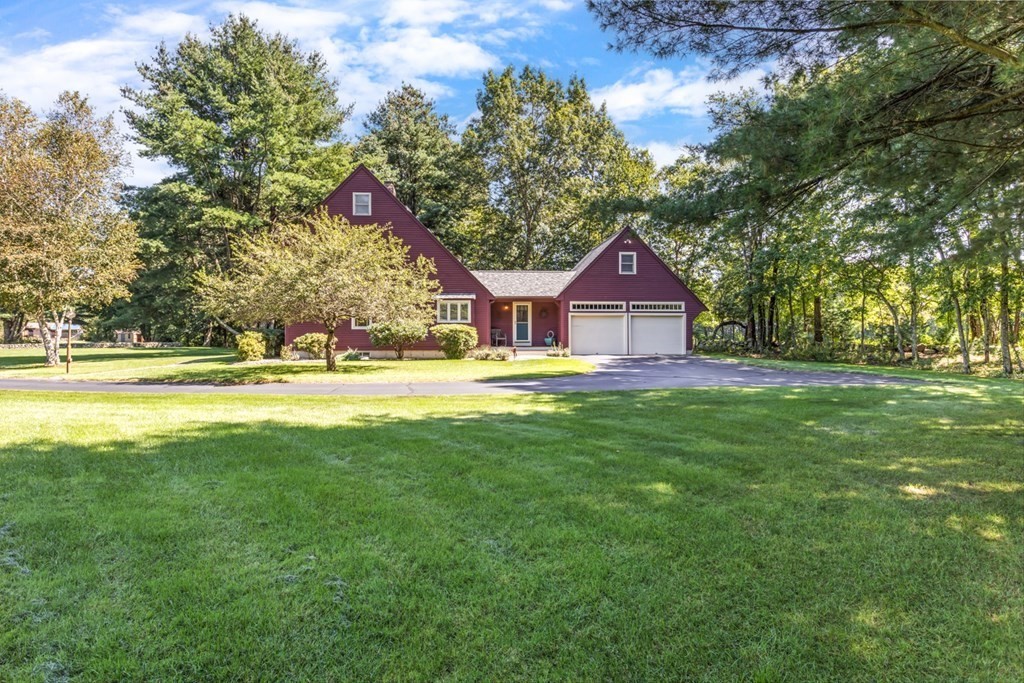 8 Mill River Drive Mendon, MA 01756 - Photo 39 of 42 a house view with garden space and trees in the background