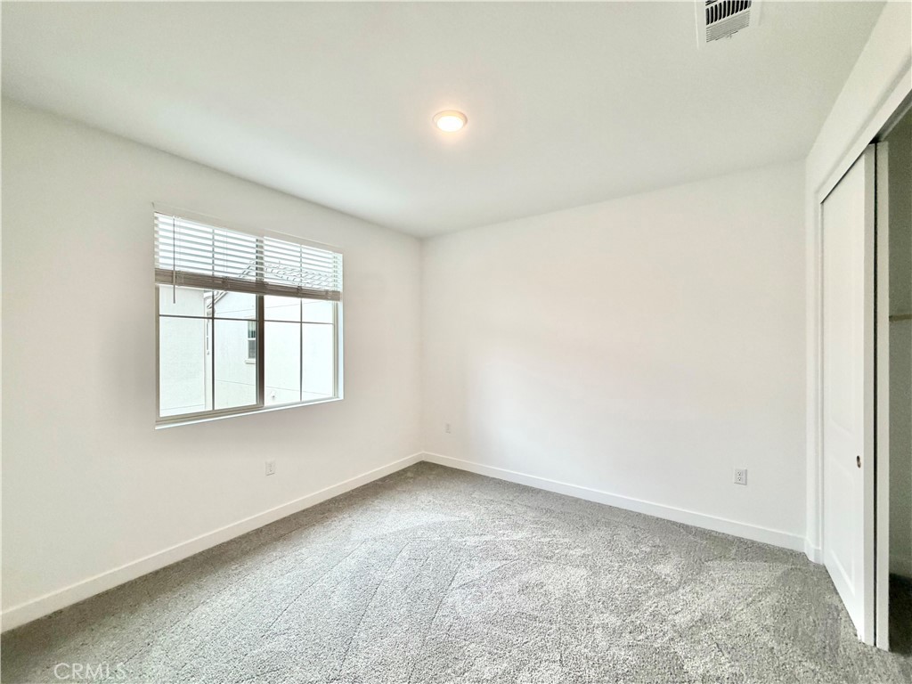 26893 Rubicon Road Menifee, CA 92586 - Photo 20 of 32 an empty room with a window