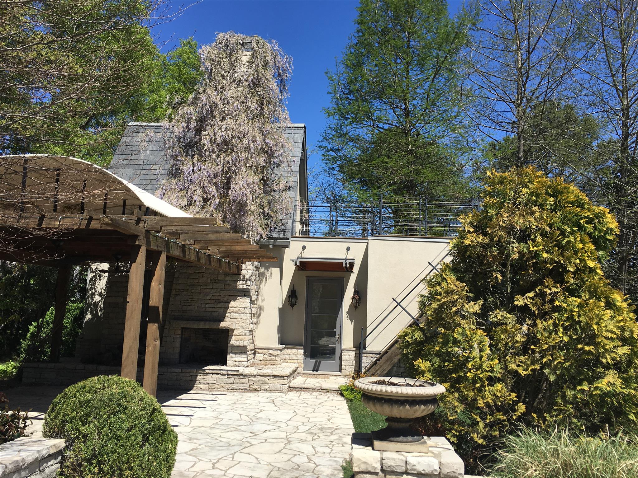 1002 Tyne Boulevard Nashville, TN 37220 - Photo 4 of 4 a view of a patio with table and chairs and potted plants