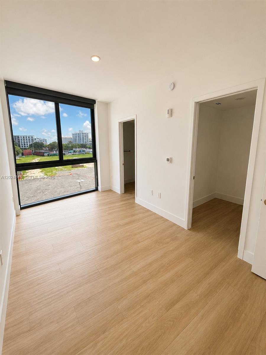 90 Northeast 32nd Street, Unit 301 Miami, FL 33127 - Photo 4 of 21 a view of an empty room with a window