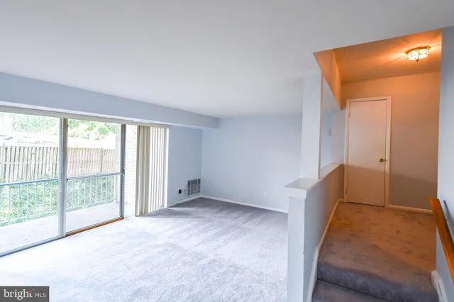 a view of an empty room and wooden floor