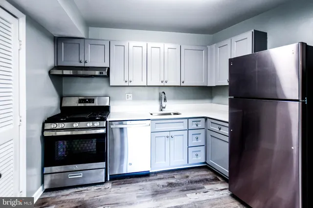 a kitchen with a refrigerator sink and cabinets