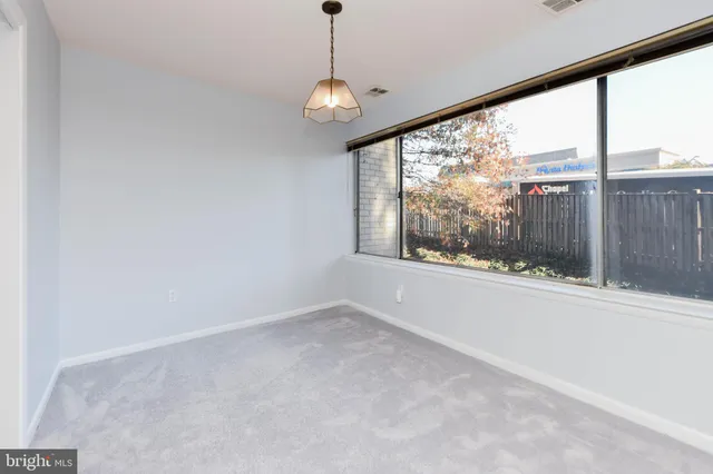 a view of an empty room with windows