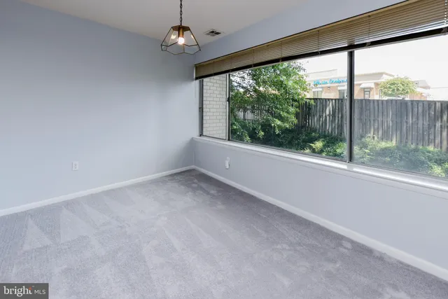 an empty room with wooden floor and outdoor space