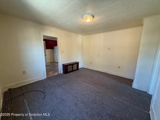 a view of empty room with cabinet