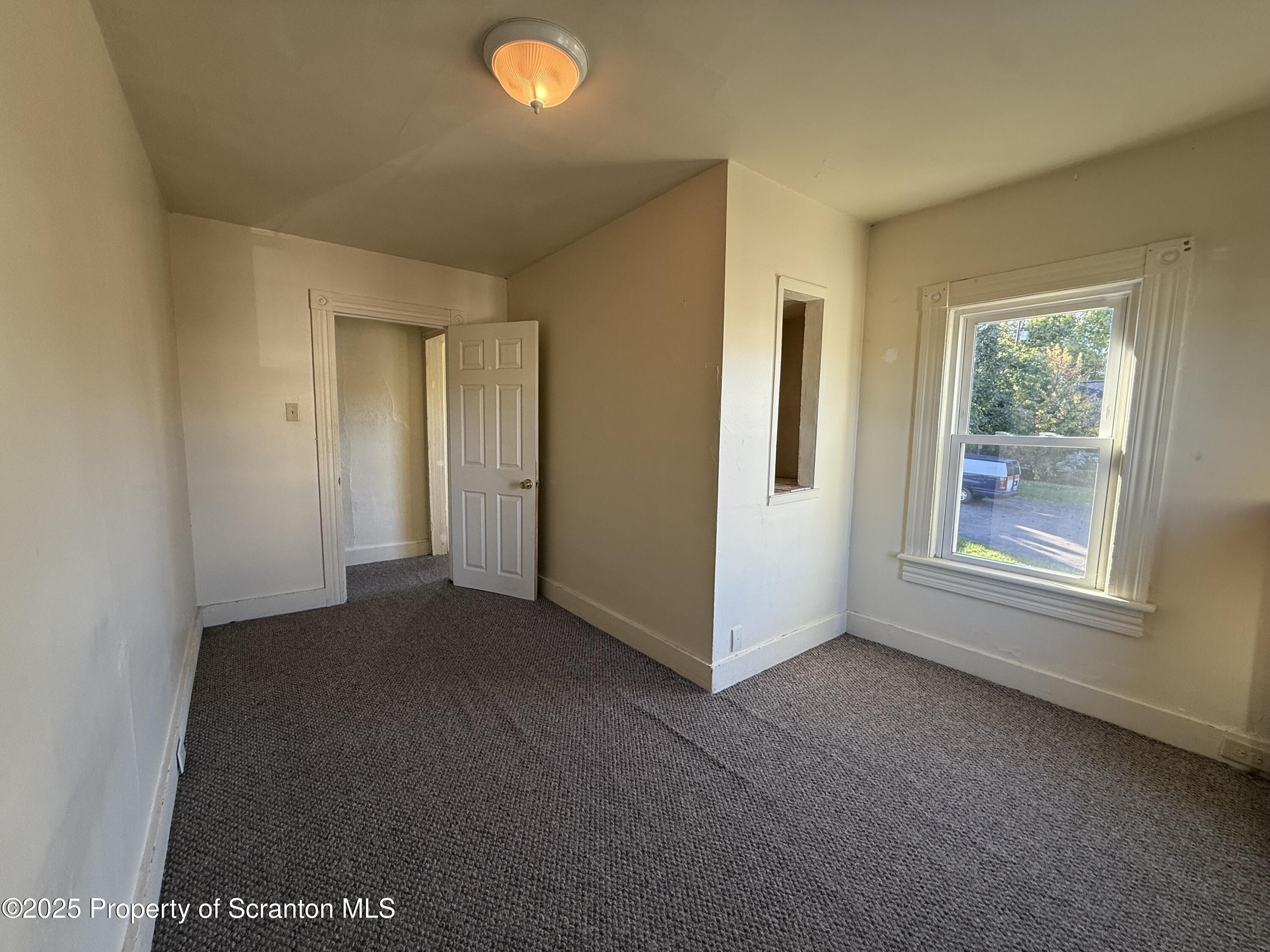 1315 Farr Street, Unit 2 Scranton, PA 18504 - Photo 10 of 14 a view of a livingroom with an empty space and a window