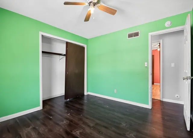 a view of room with window and wooden floor