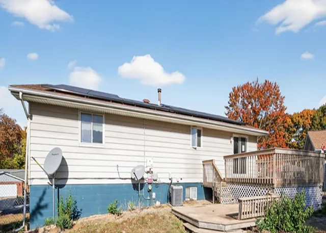 a backyard of a house with table and chairs