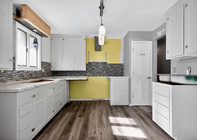 a kitchen with a sink and cabinets