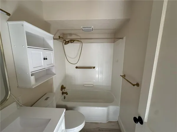 a bathroom with a shower a toilet and a shower