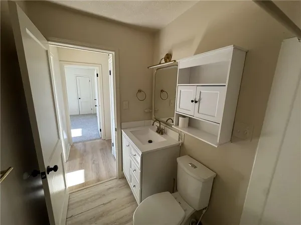 a bathroom with a sink mirror toilet and shower