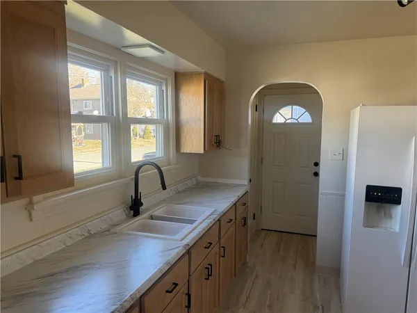a kitchen with a sink cabinets and window