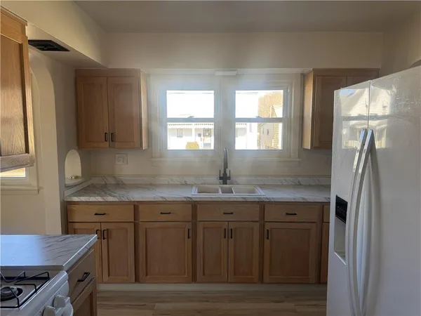 a kitchen with a sink stove and refrigerator