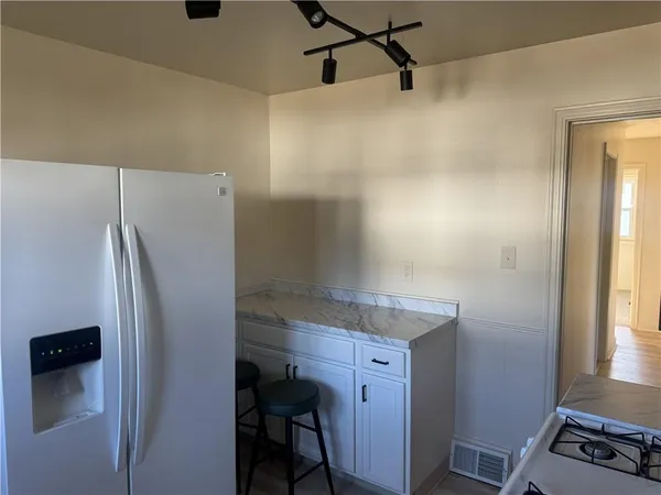 a kitchen with a refrigerator and a window