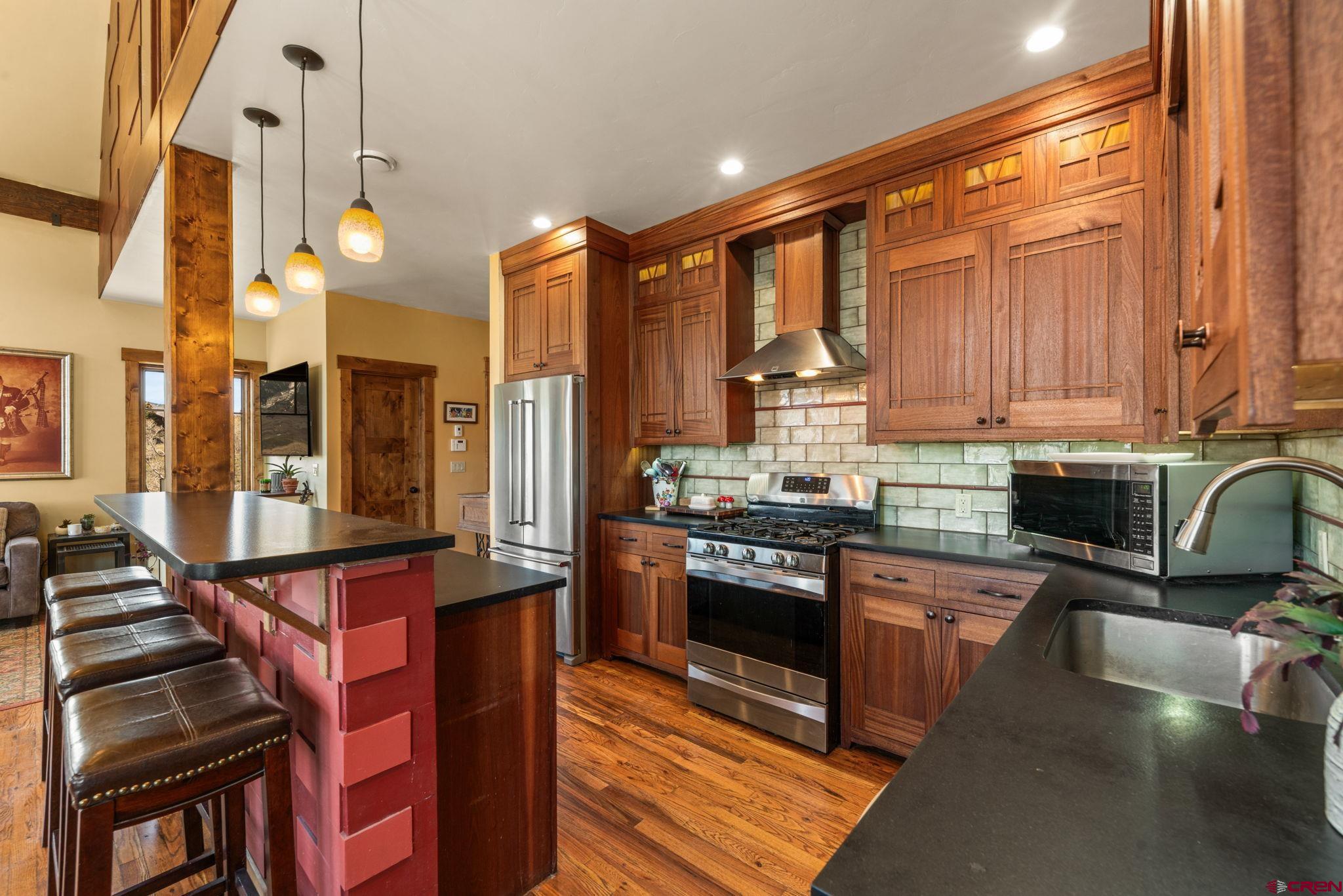 3893 Bryant Avenue Crested Butte, CO 81224 - Photo 12 of 45 a kitchen with stainless steel appliances granite countertop a stove and a sink
