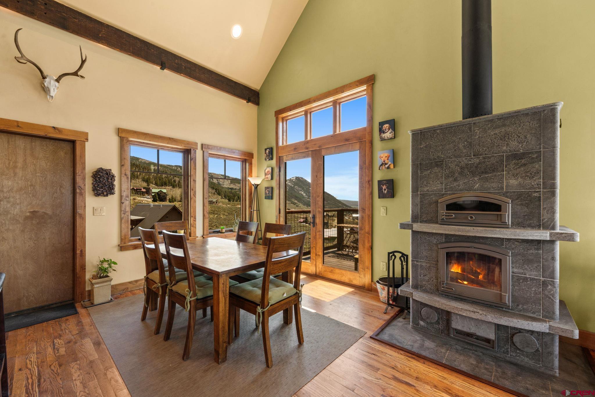 3893 Bryant Avenue Crested Butte, CO 81224 - Photo 15 of 45 a dining room with furniture a fireplace and wooden floor