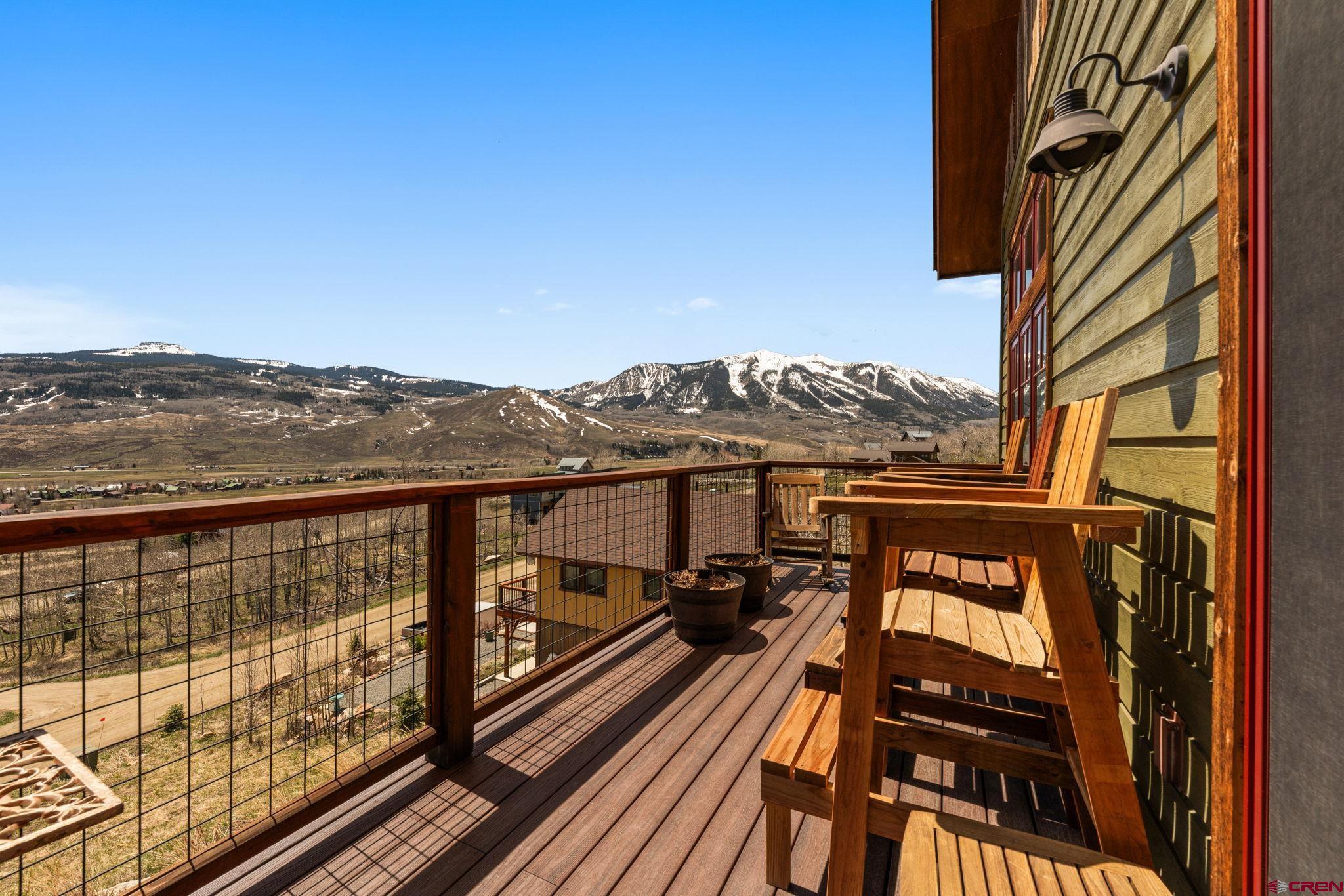 3893 Bryant Avenue Crested Butte, CO 81224 - Photo 16 of 45 a view of a balcony with wooden floor and a floor to ceiling window