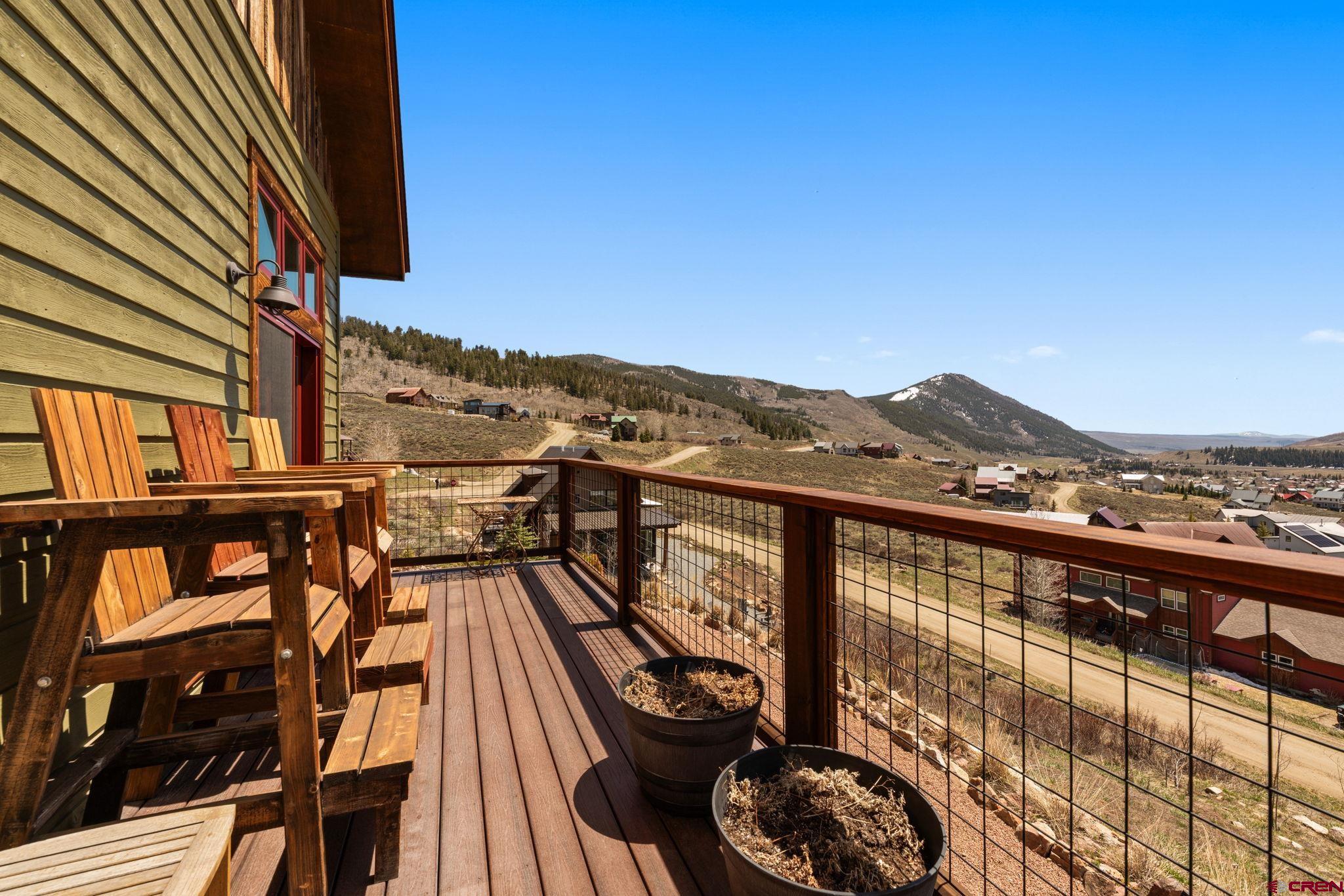 3893 Bryant Avenue Crested Butte, CO 81224 - Photo 17 of 45 a view of a balcony with chairs and wooden floor