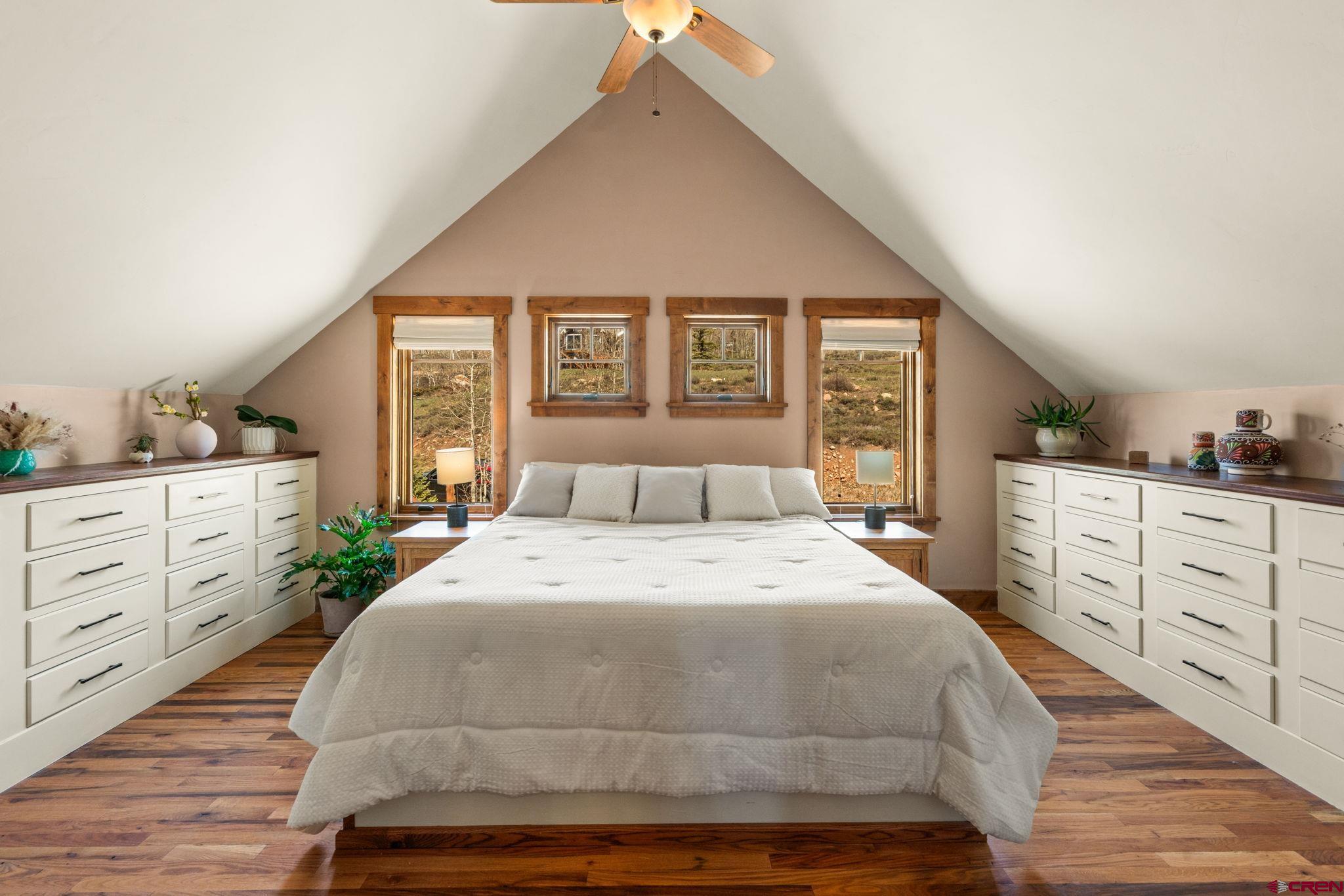 3893 Bryant Avenue Crested Butte, CO 81224 - Photo 20 of 45 a spacious bedroom with a large bed and a dresser