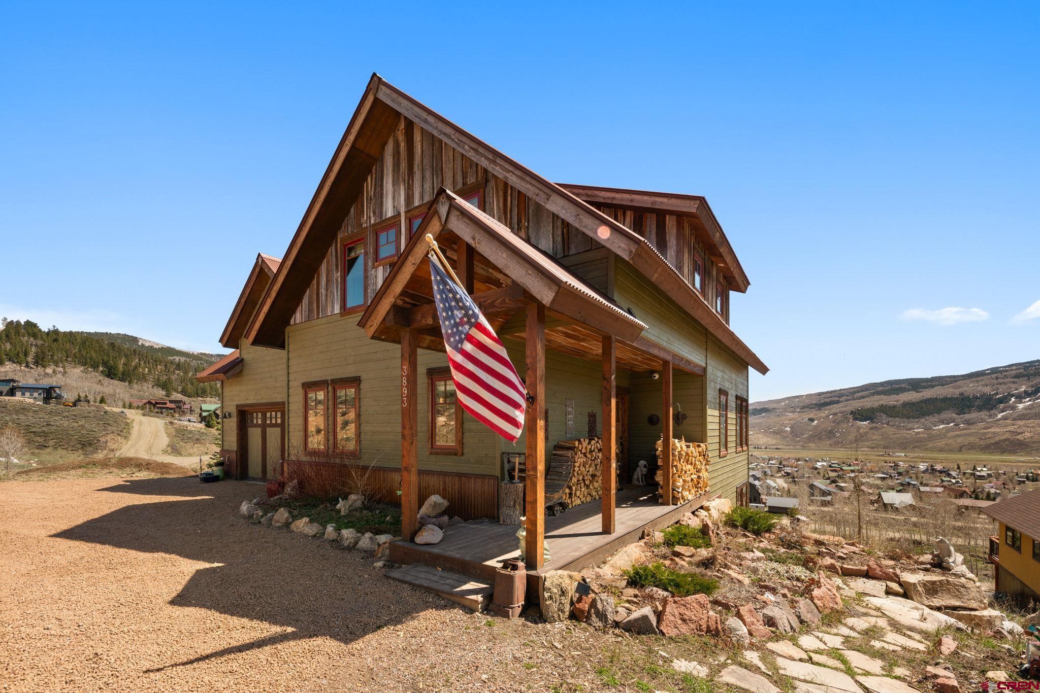 3893 Bryant Avenue Crested Butte, CO 81224 - Photo 2 of 45 a front view of a house with a yard