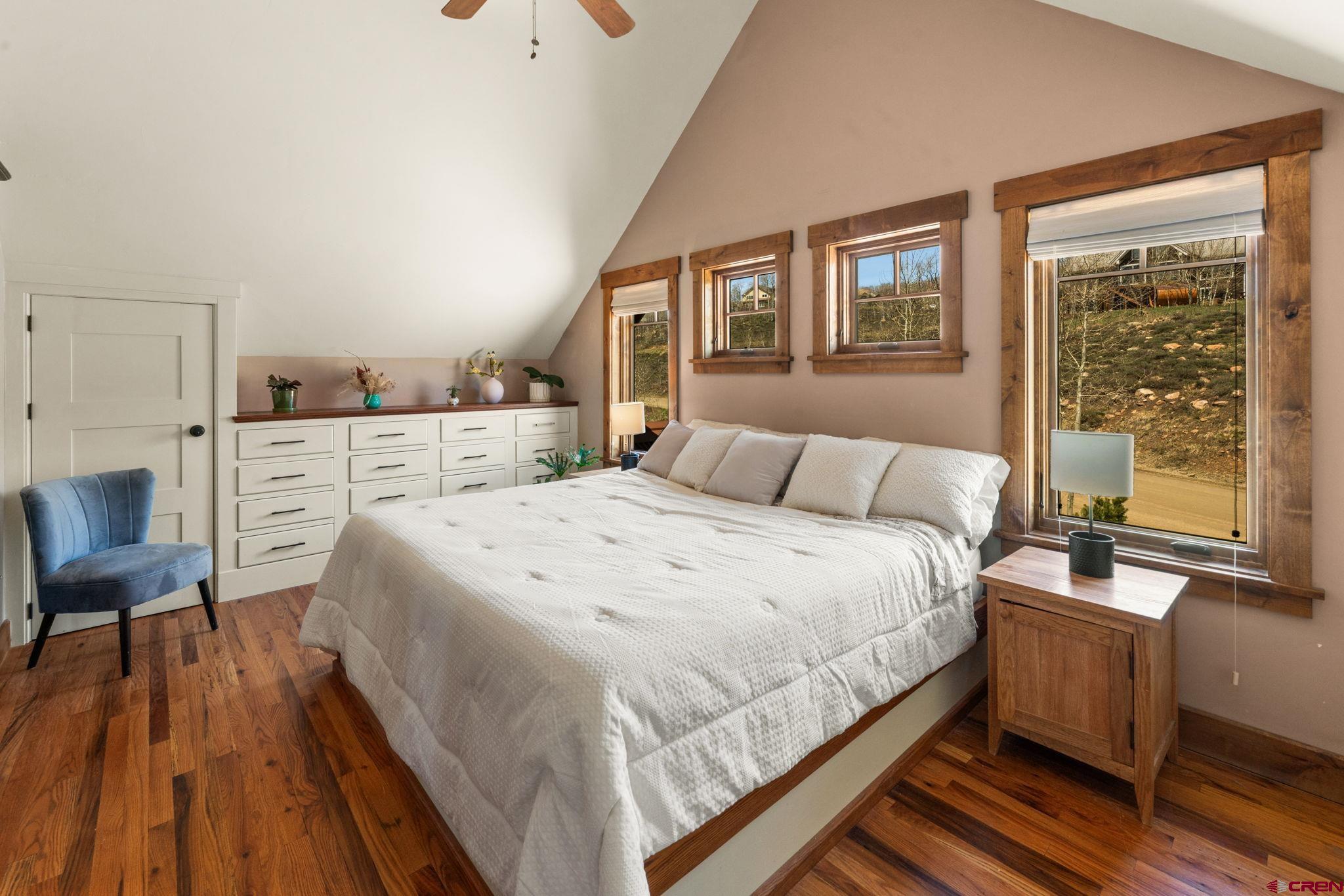 3893 Bryant Avenue Crested Butte, CO 81224 - Photo 21 of 45 a bedroom with a bed and wooden floor