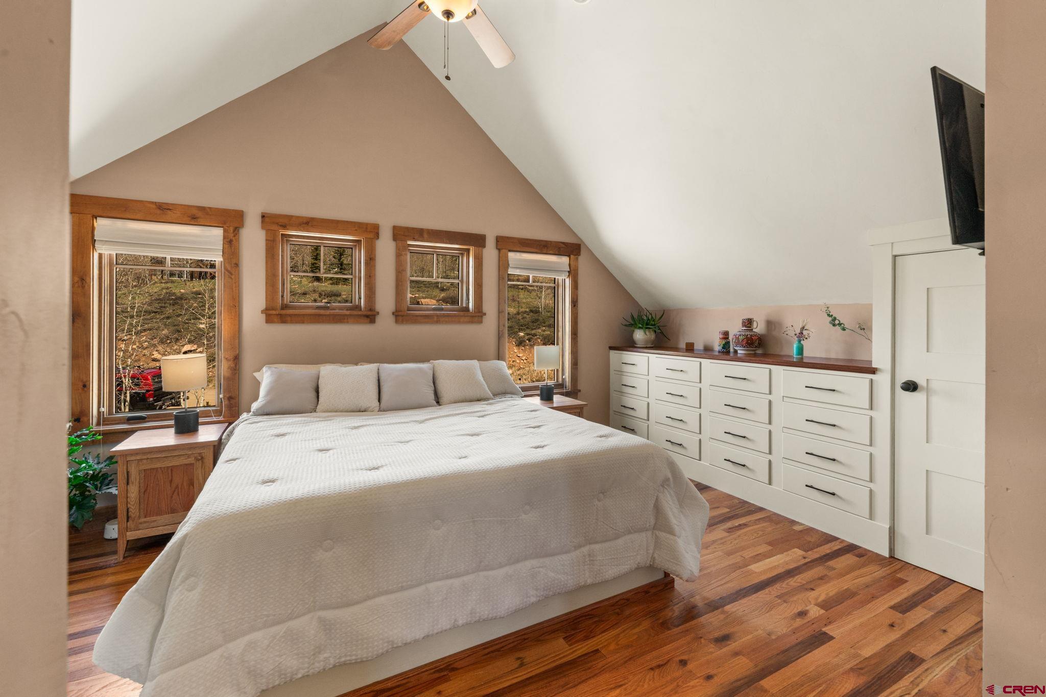 3893 Bryant Avenue Crested Butte, CO 81224 - Photo 22 of 45 a spacious bedroom with a bed and a flat tv screen