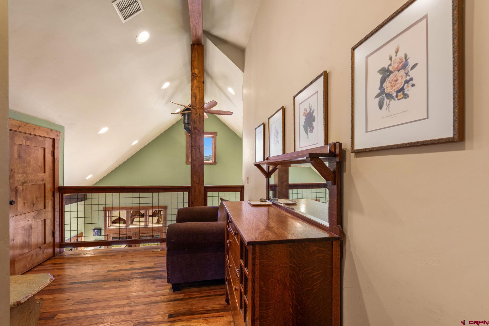3893 Bryant Avenue Crested Butte, CO 81224 - Photo 26 of 45 a hallway with a large mirror on a dresser with wooden floor