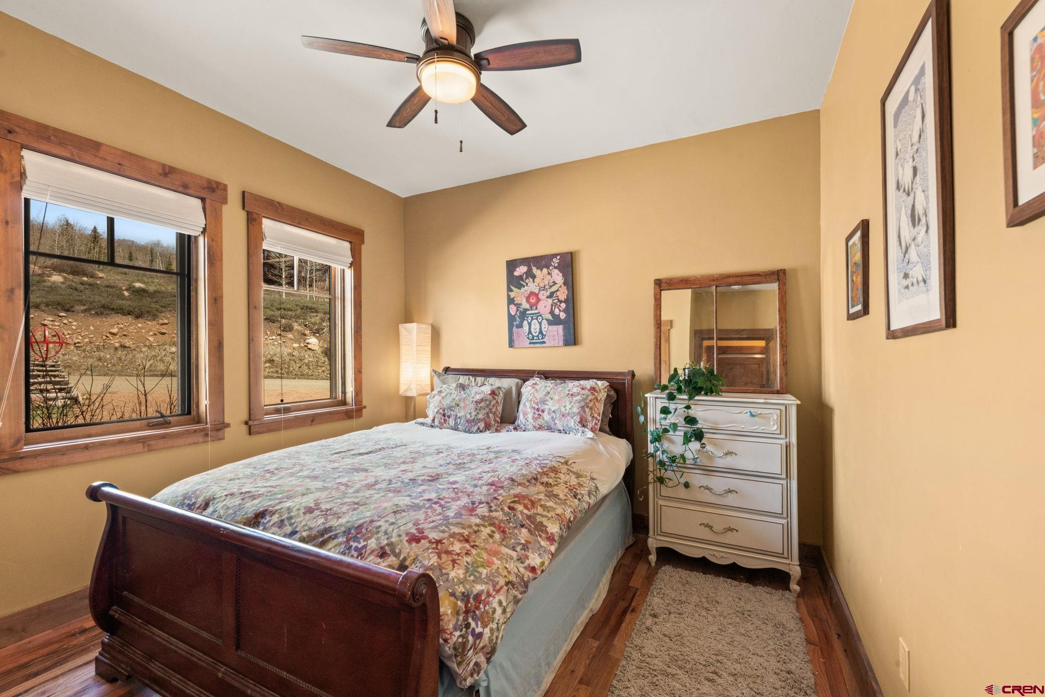 3893 Bryant Avenue Crested Butte, CO 81224 - Photo 29 of 45 a bedroom with a large bed and a window
