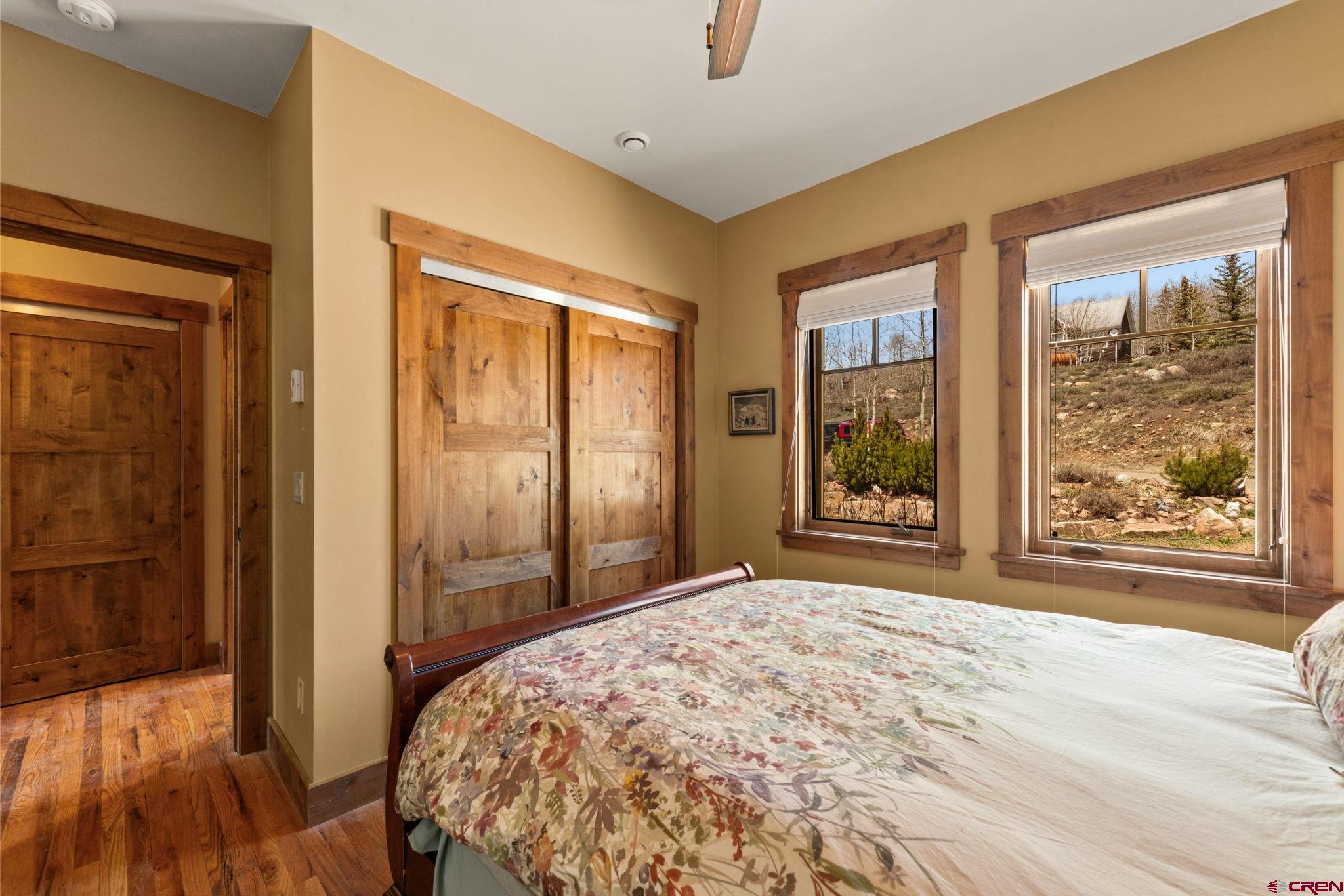 3893 Bryant Avenue Crested Butte, CO 81224 - Photo 30 of 45 a bedroom with a bed and a large window with outer view