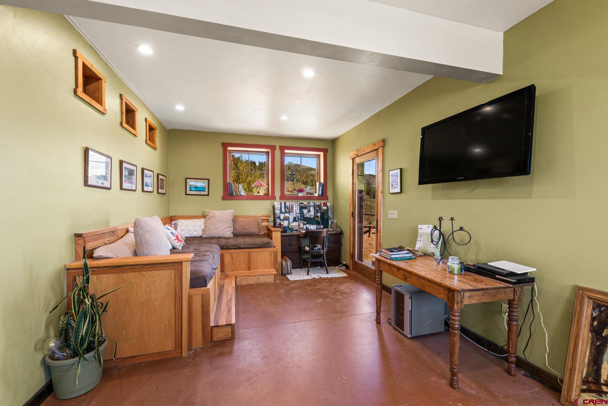 3893 Bryant Avenue Crested Butte, CO 81224 - Photo 36 of 45 a living room with furniture and a flat screen tv