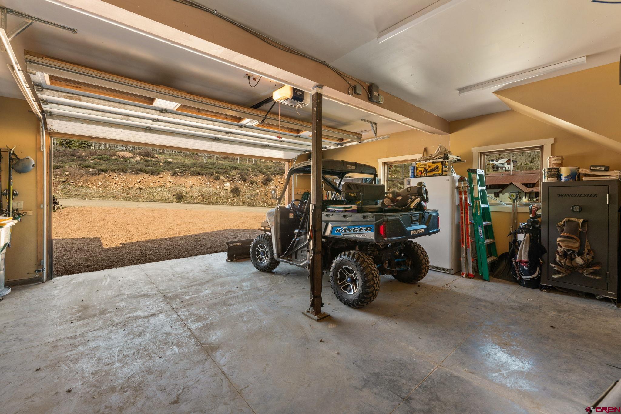 3893 Bryant Avenue Crested Butte, CO 81224 - Photo 41 of 45 a view of a garage with parked cars