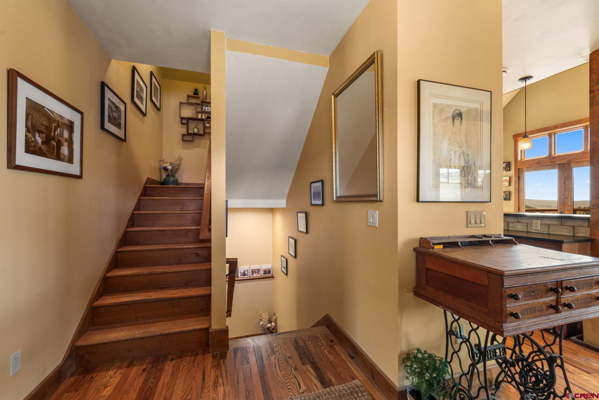 3893 Bryant Avenue Crested Butte, CO 81224 - Photo 5 of 45 a view of a hallway with furniture and wooden floor