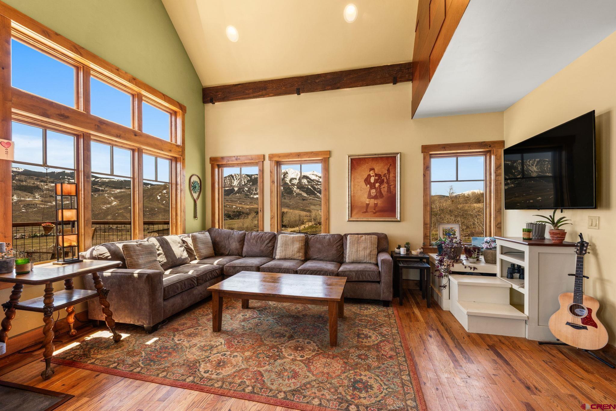 3893 Bryant Avenue Crested Butte, CO 81224 - Photo 7 of 45 a living room with furniture tv and a flat screen tv