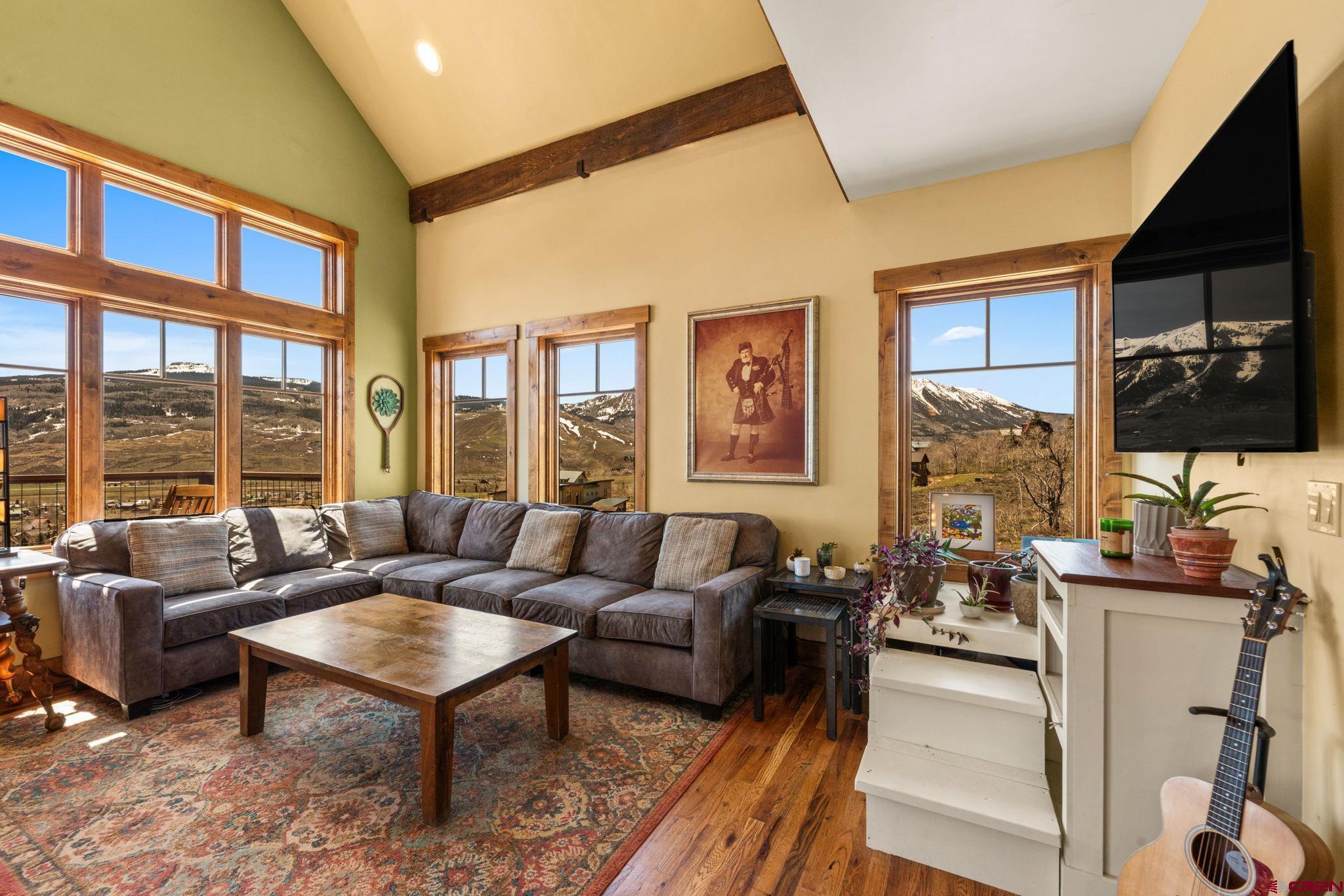 3893 Bryant Avenue Crested Butte, CO 81224 - Photo 8 of 45 a living room with furniture a flat screen tv and a large window