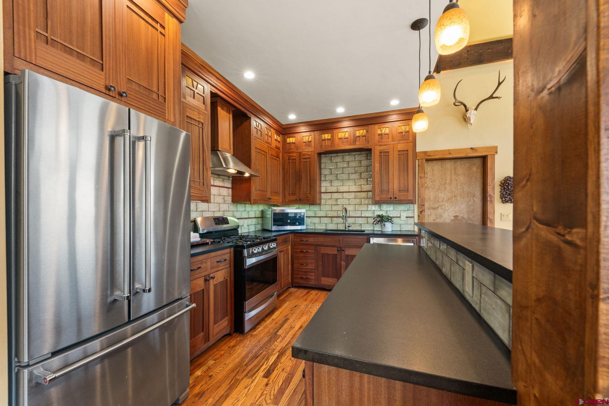 3893 Bryant Avenue Crested Butte, CO 81224 - Photo 10 of 45 a kitchen with stainless steel appliances a refrigerator and a stove