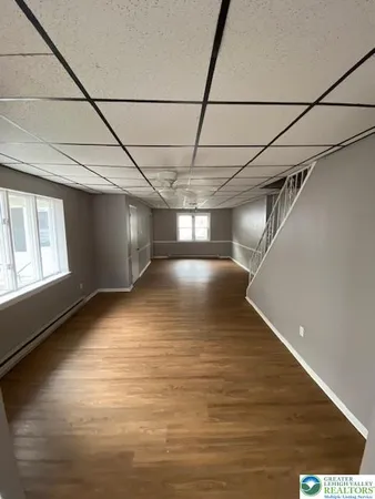 a view of empty room with wooden floor