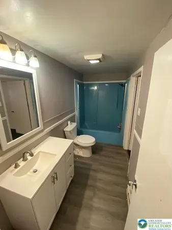 a bathroom with a sink a toilet and a mirror