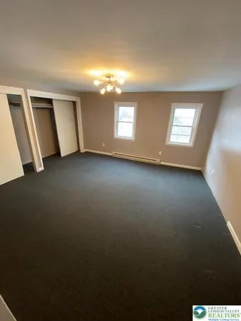 a view of a livingroom with wooden floor and window
