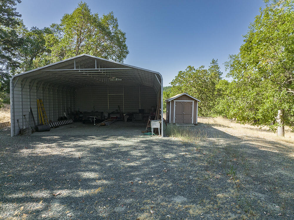 375 Oak Ranch Road Grants Pass, OR 97526 - Photo 56 of 57 a backyard of a house with a yard and garage