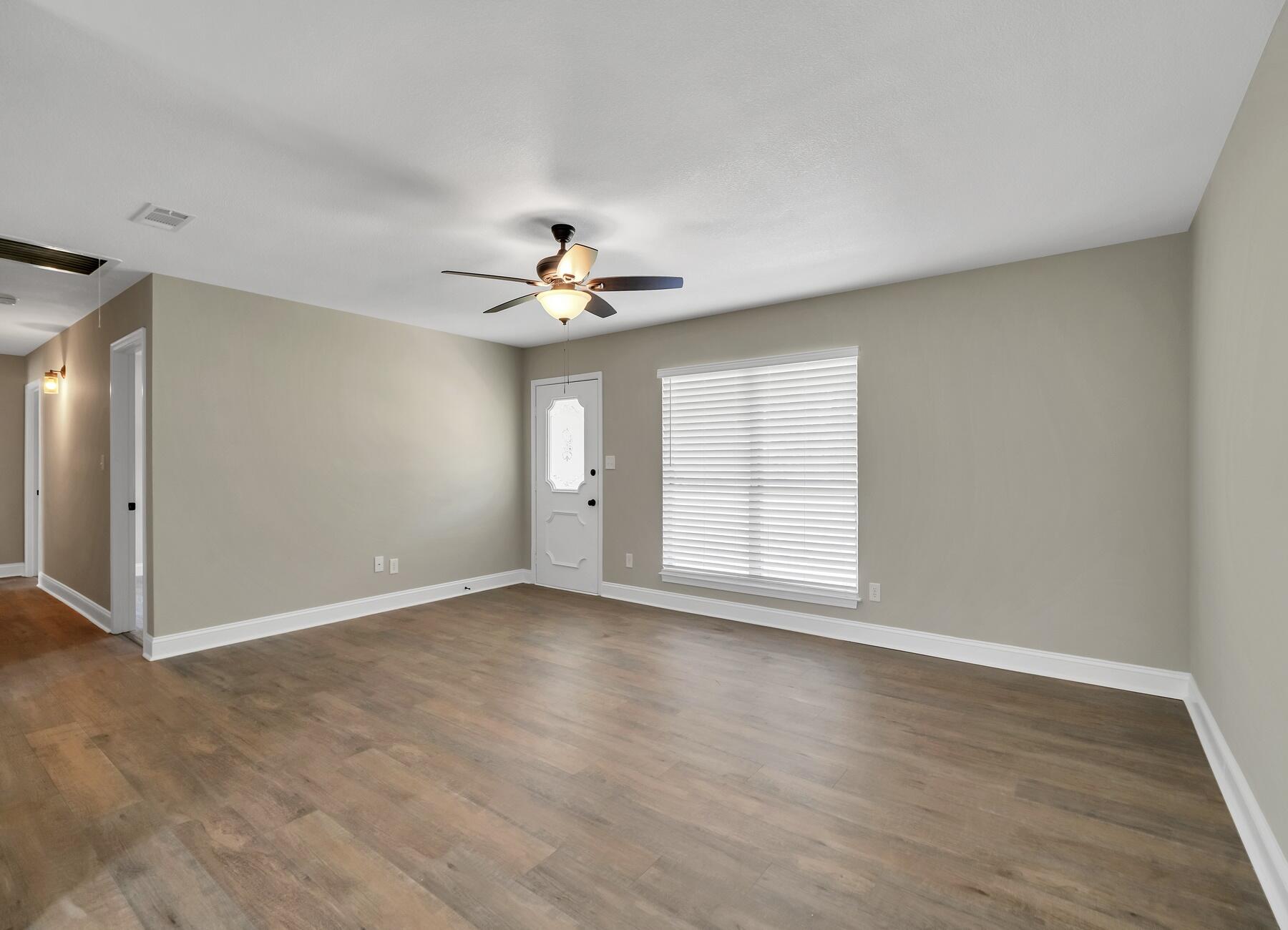 6935 Jasper Street Navarre, FL 32566 - Photo 16 of 45 a view of an empty room with a chandelier fan