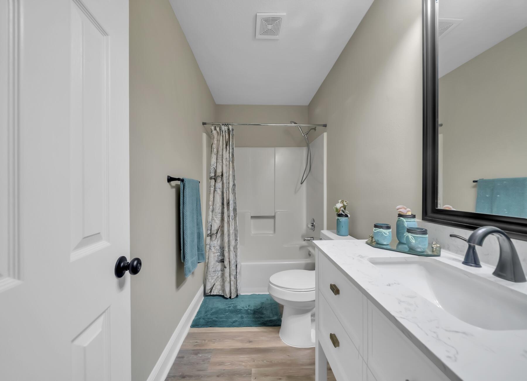 6935 Jasper Street Navarre, FL 32566 - Photo 18 of 45 a bathroom with a granite countertop sink and a mirror
