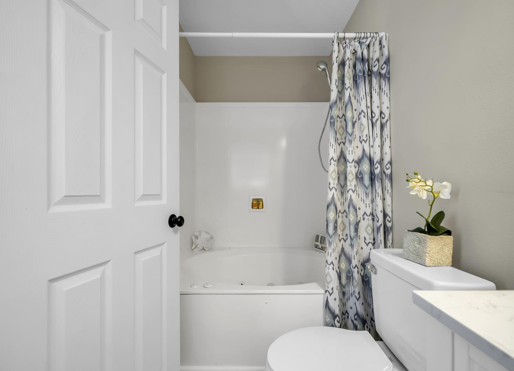 6935 Jasper Street Navarre, FL 32566 - Photo 19 of 45 a white toilet sitting next to a white tub