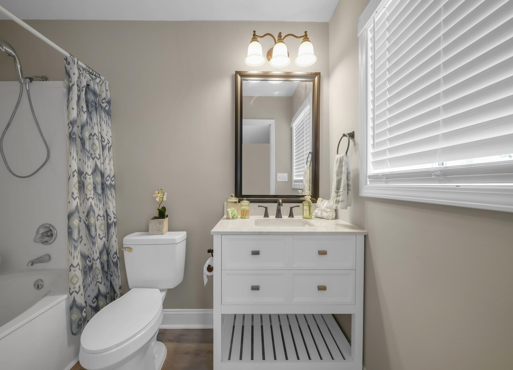 6935 Jasper Street Navarre, FL 32566 - Photo 20 of 45 a bathroom with a toilet a sink and a mirror