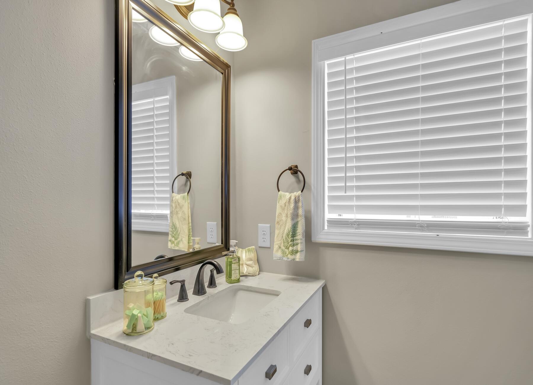 6935 Jasper Street Navarre, FL 32566 - Photo 21 of 45 a bathroom with a sink and a mirror