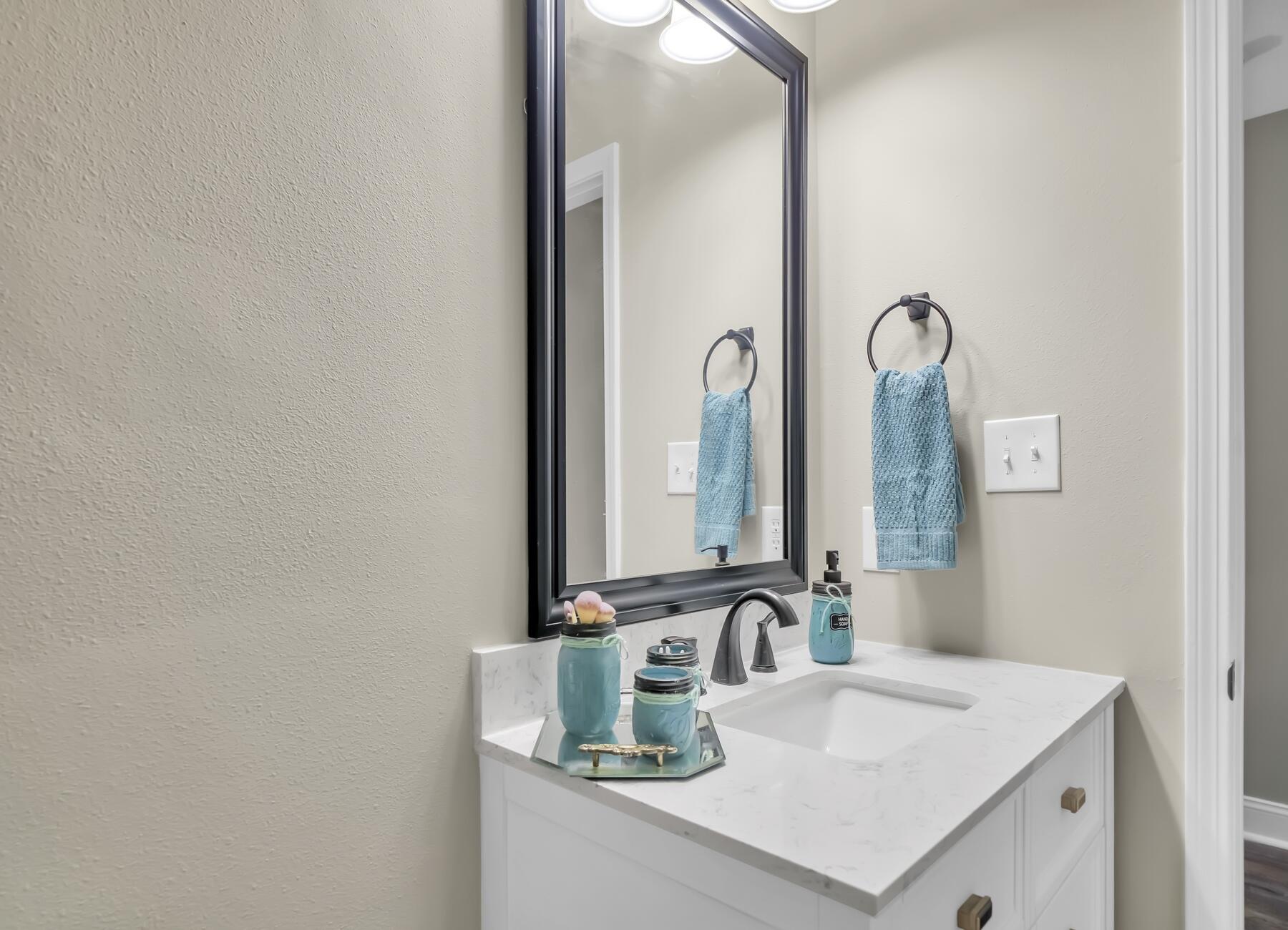 6935 Jasper Street Navarre, FL 32566 - Photo 22 of 45 a bathroom with a sink and a mirror