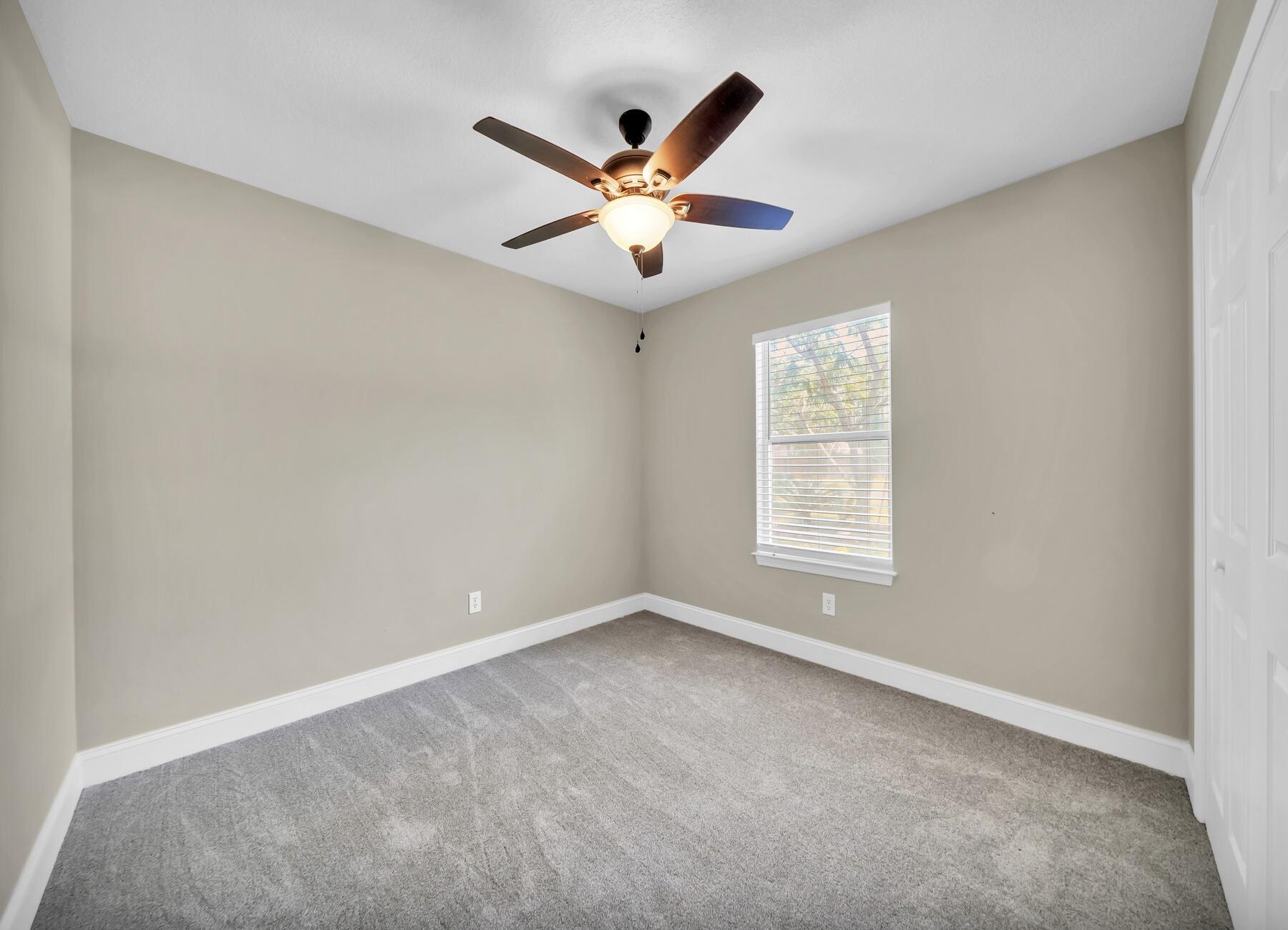 6935 Jasper Street Navarre, FL 32566 - Photo 24 of 45 a view of an empty room with window and ceiling fan