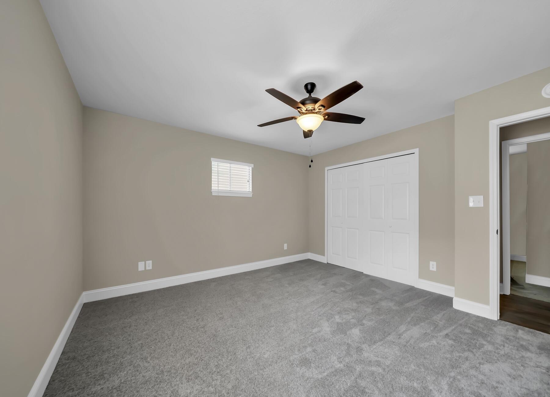 6935 Jasper Street Navarre, FL 32566 - Photo 30 of 45 an empty room with a window and a fan