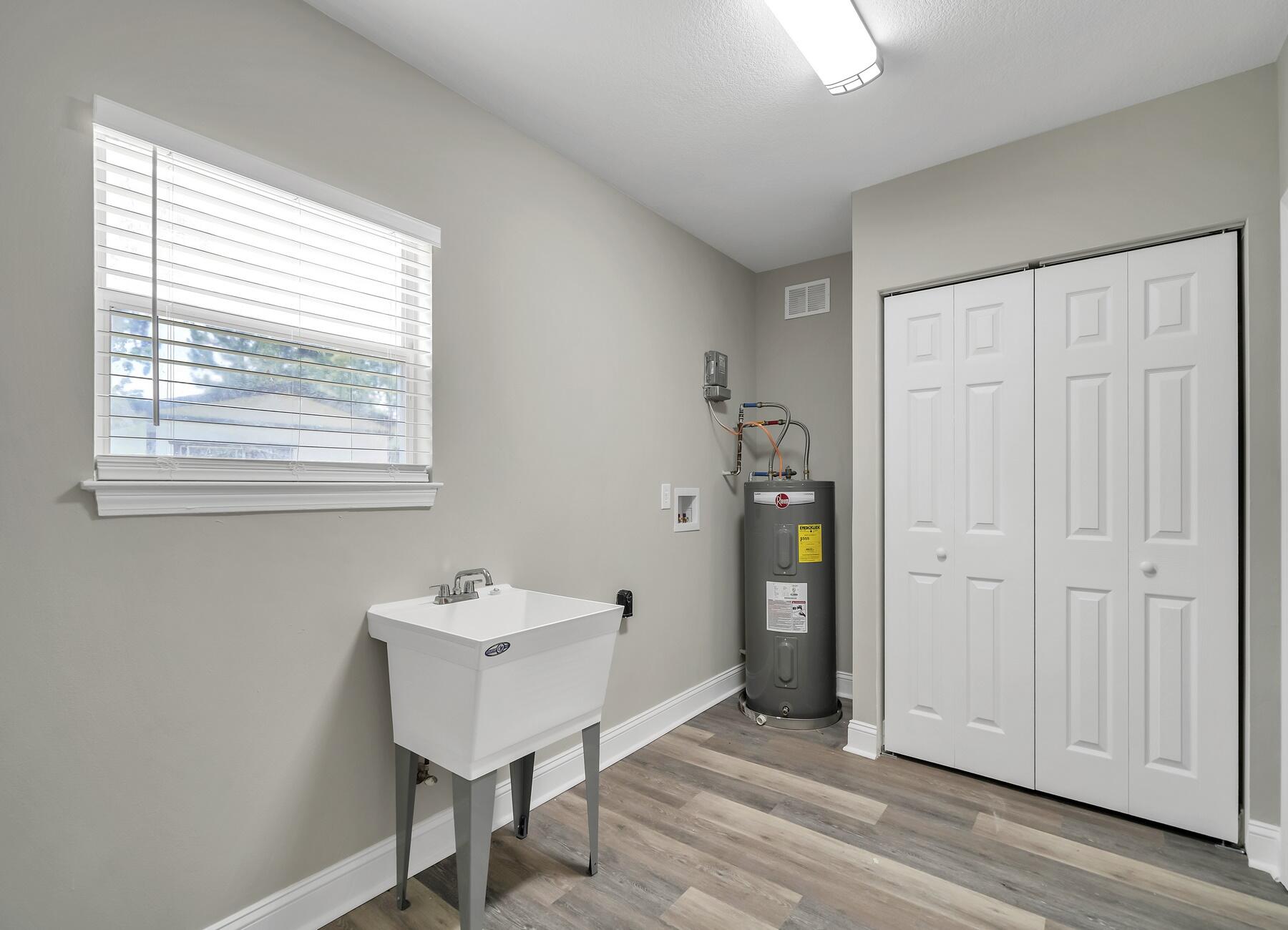 6935 Jasper Street Navarre, FL 32566 - Photo 32 of 45 a bathroom with a sink and a window