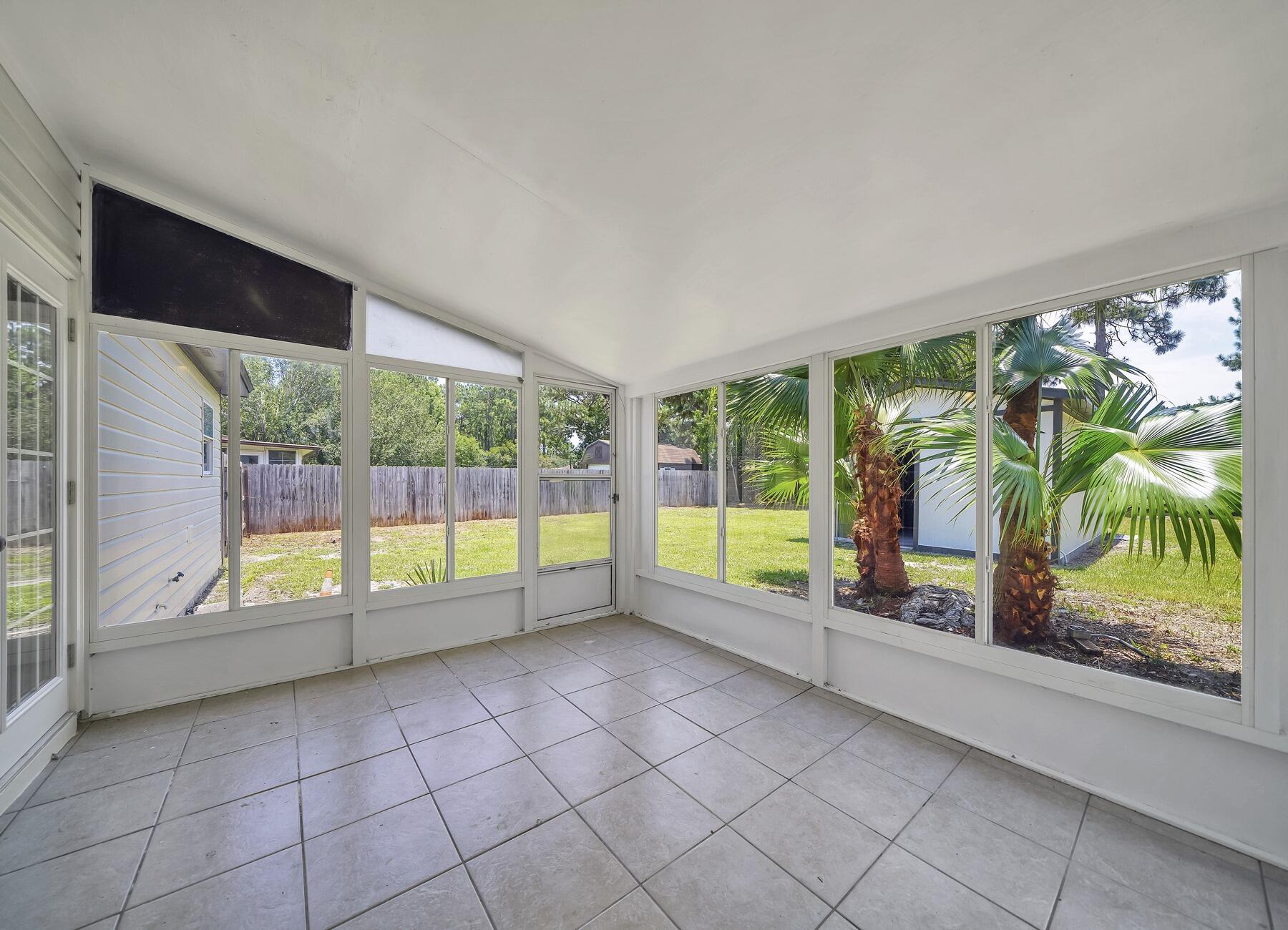 6935 Jasper Street Navarre, FL 32566 - Photo 34 of 45 a view of an entryway with a garden